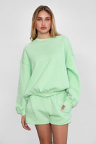 Relaxed fit fleece sweater for women with dropped shoulders and plush cozy fabric in pastel lime