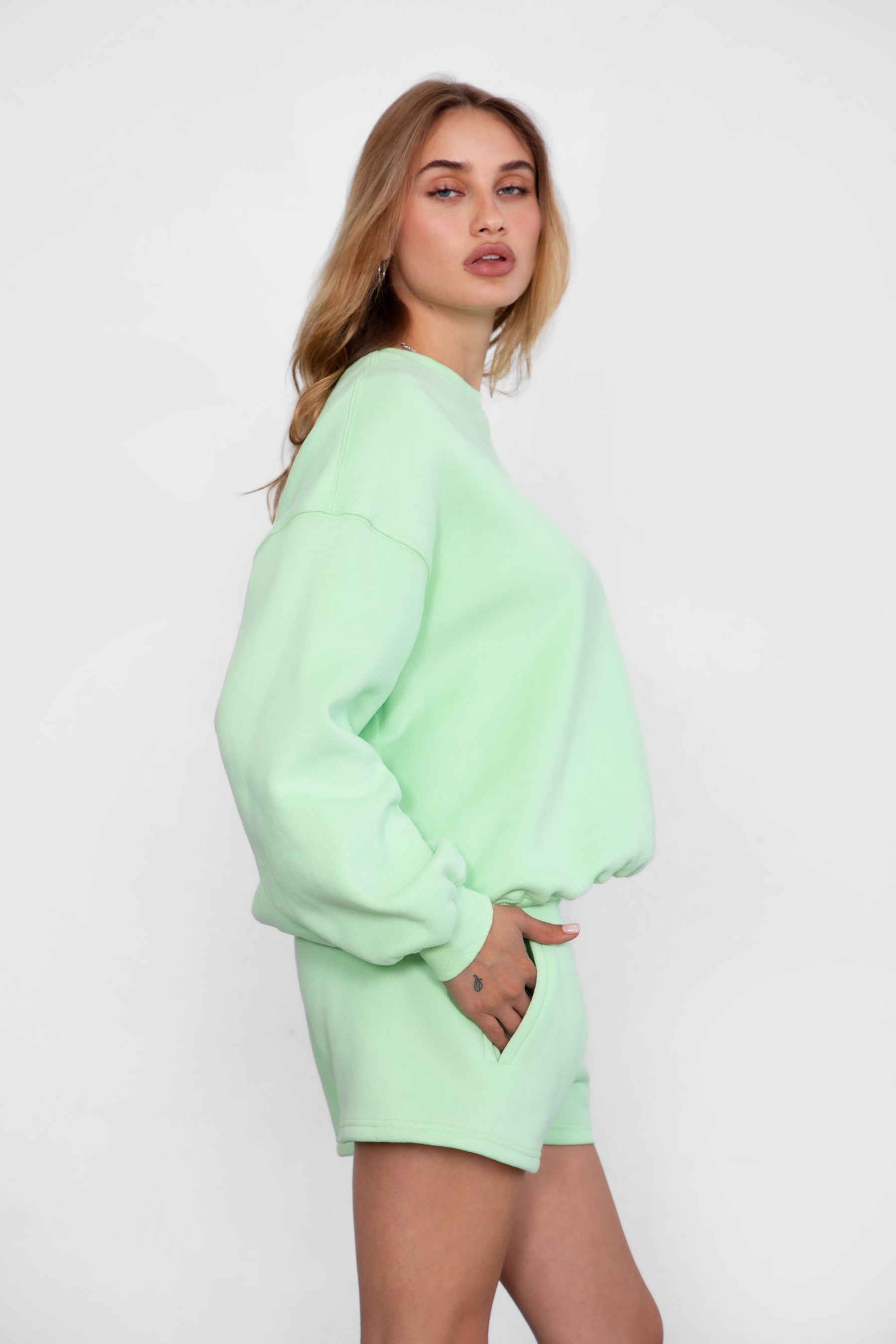 Relaxed fit fleece sweater for women with dropped shoulders and plush cozy fabric in pastel lime