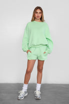 Relaxed fit fleece sweater for women with dropped shoulders and plush cozy fabric in pastel lime