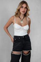 White mesh rhinestone bodysuit with fringe detail and adjustable straps for a glam look