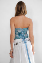 Elegant tapestry bustier top with long asymmetrical hem and silver front fastening