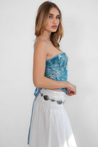 Elegant tapestry bustier top with long asymmetrical hem and silver front fastening