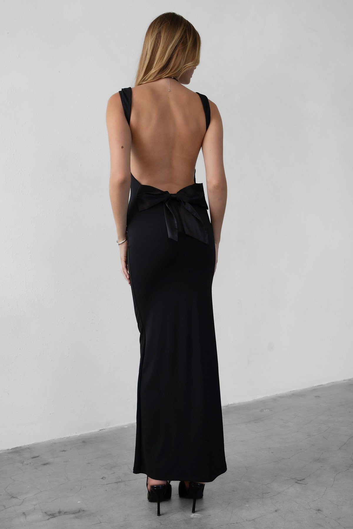 Elegant white floor-length dress with cowl neckline and backless design