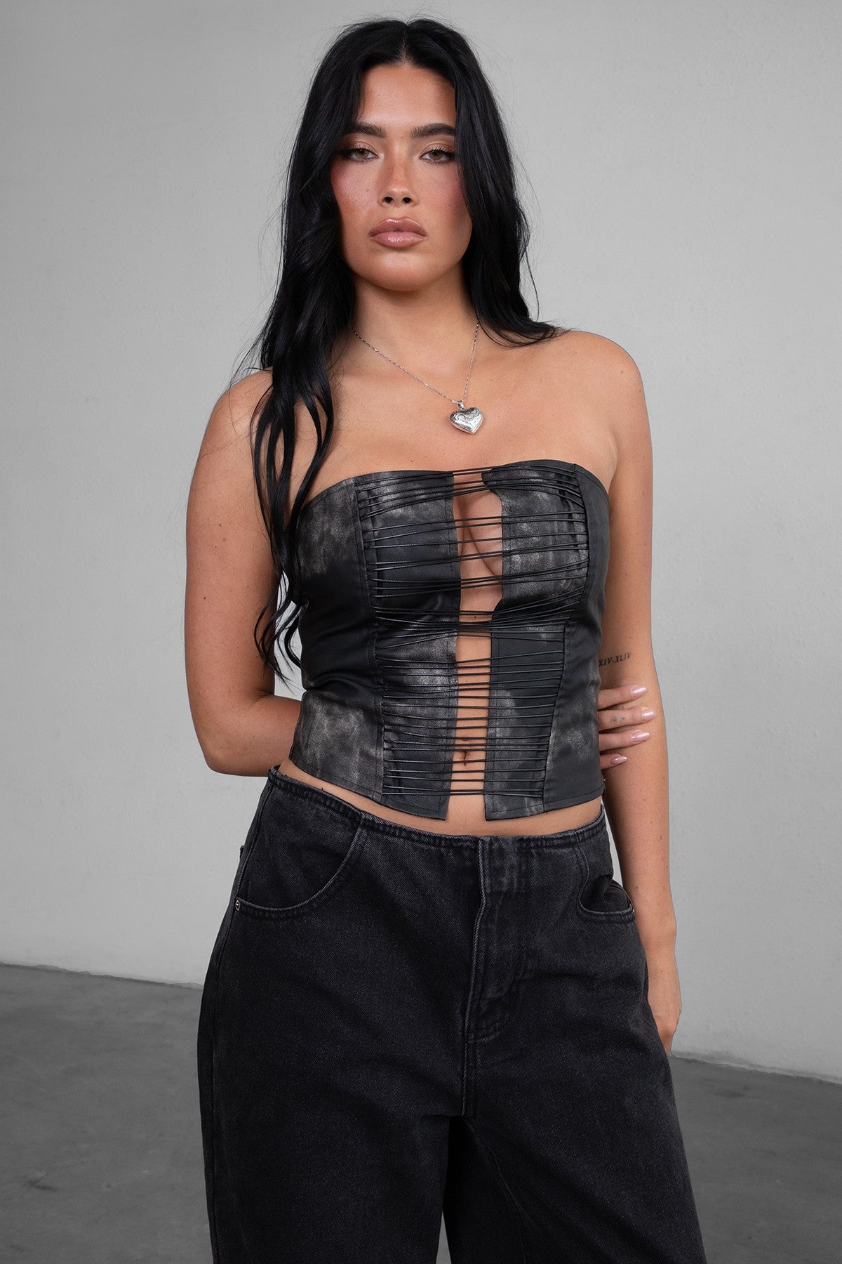 TIC TOC HELEN distressed PU leather corset top in black with strap details and hidden zipper