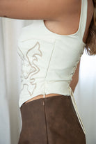 TIC TOC suede corset in cream with adjustable back and faux buttons