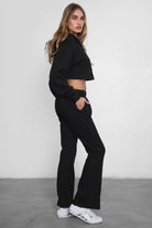 Women's flare fleece sweatpants in black, featuring side pockets and thick fleece fabric