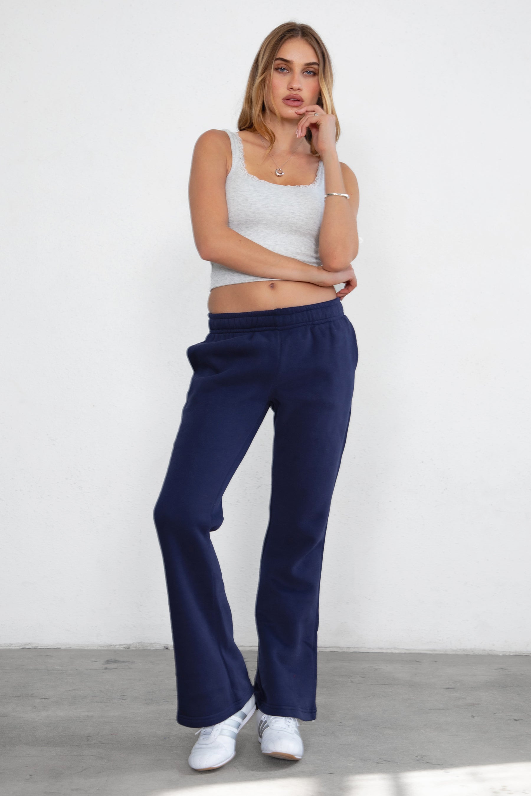 Women's flare fleece sweatpants in navy, featuring side pockets and thick fleece fabric