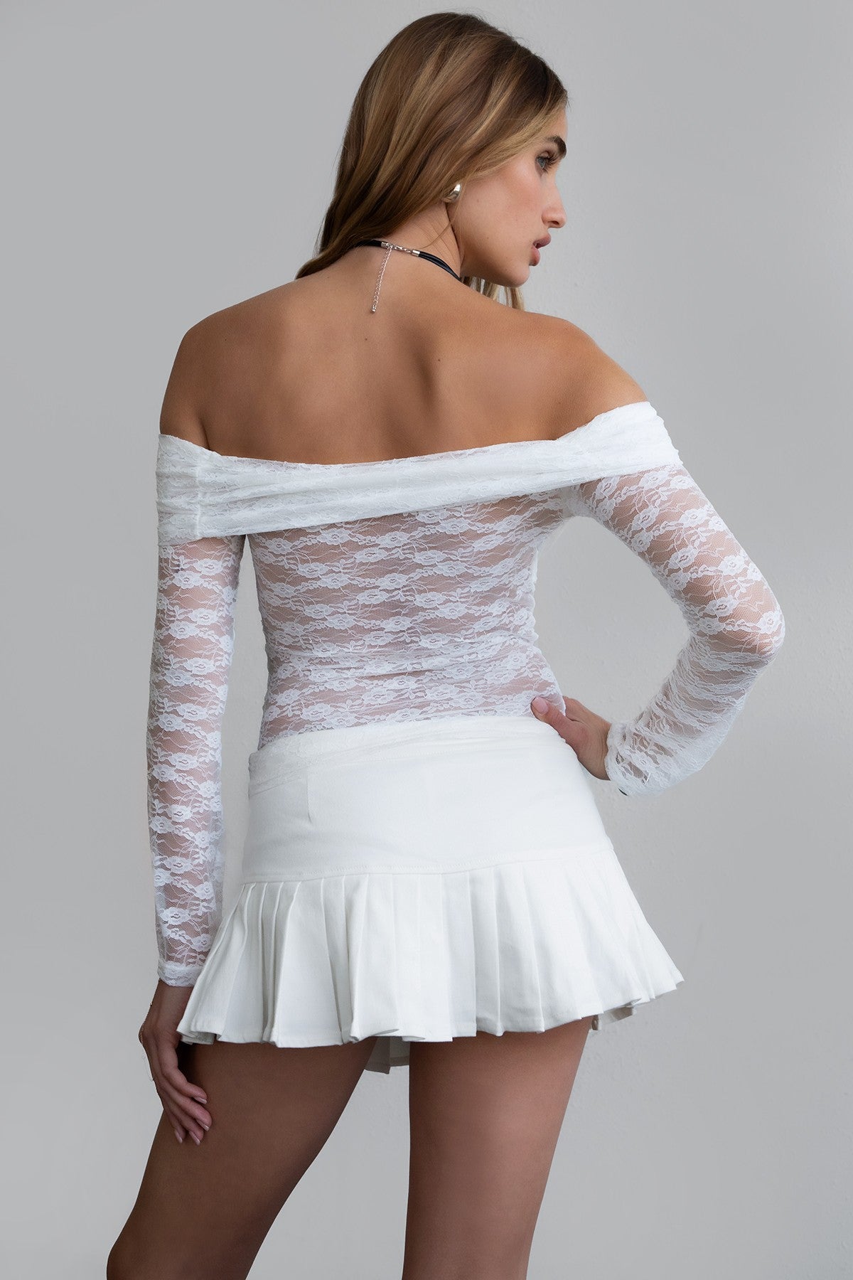 White lace off-the-shoulder blouse by TIC TOC, featuring sheer bodice and fitted sleeves