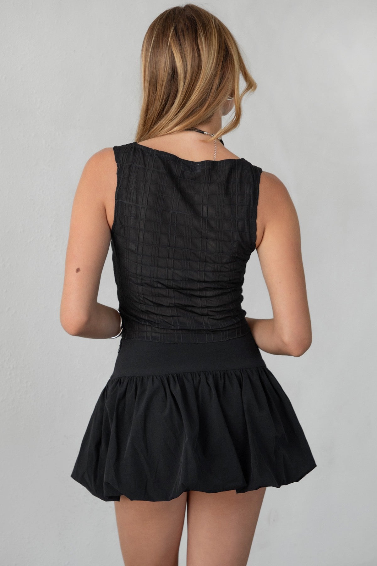 TIC TOC NADIN textured jacquard tank top in black with an asymmetric hemline