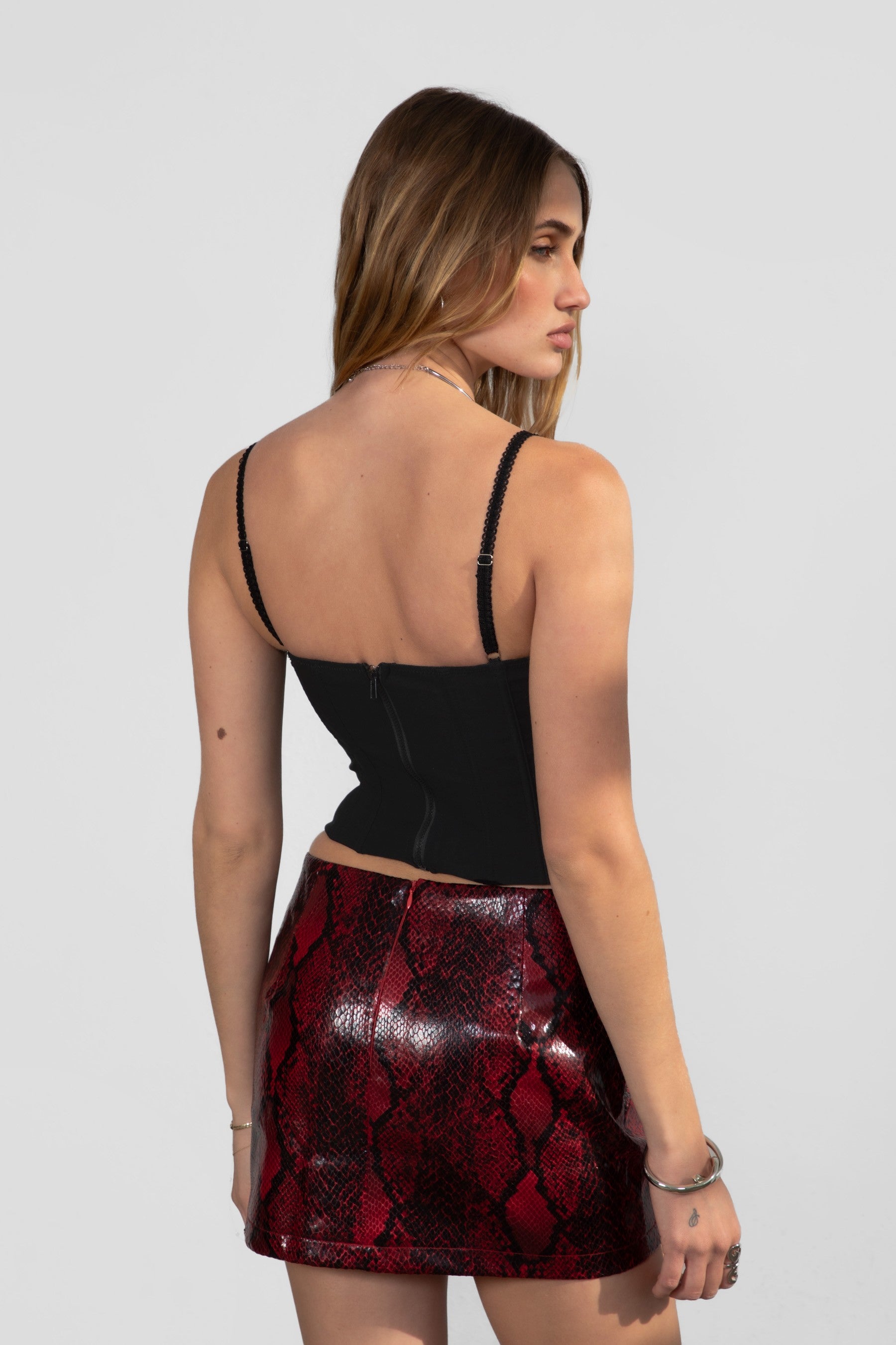 Snake print PU leather mini skirt with hidden zipper closure by TIC TOC