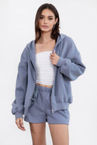  French blue oversized fleece hoodie with a functional zipper and ribbed hem, perfect for layering by Tic Toc.