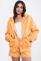 Orange zip-up fleece hoodie with a thick, warm fabric and relaxed fit, designed for casual comfort by Tic Toc.