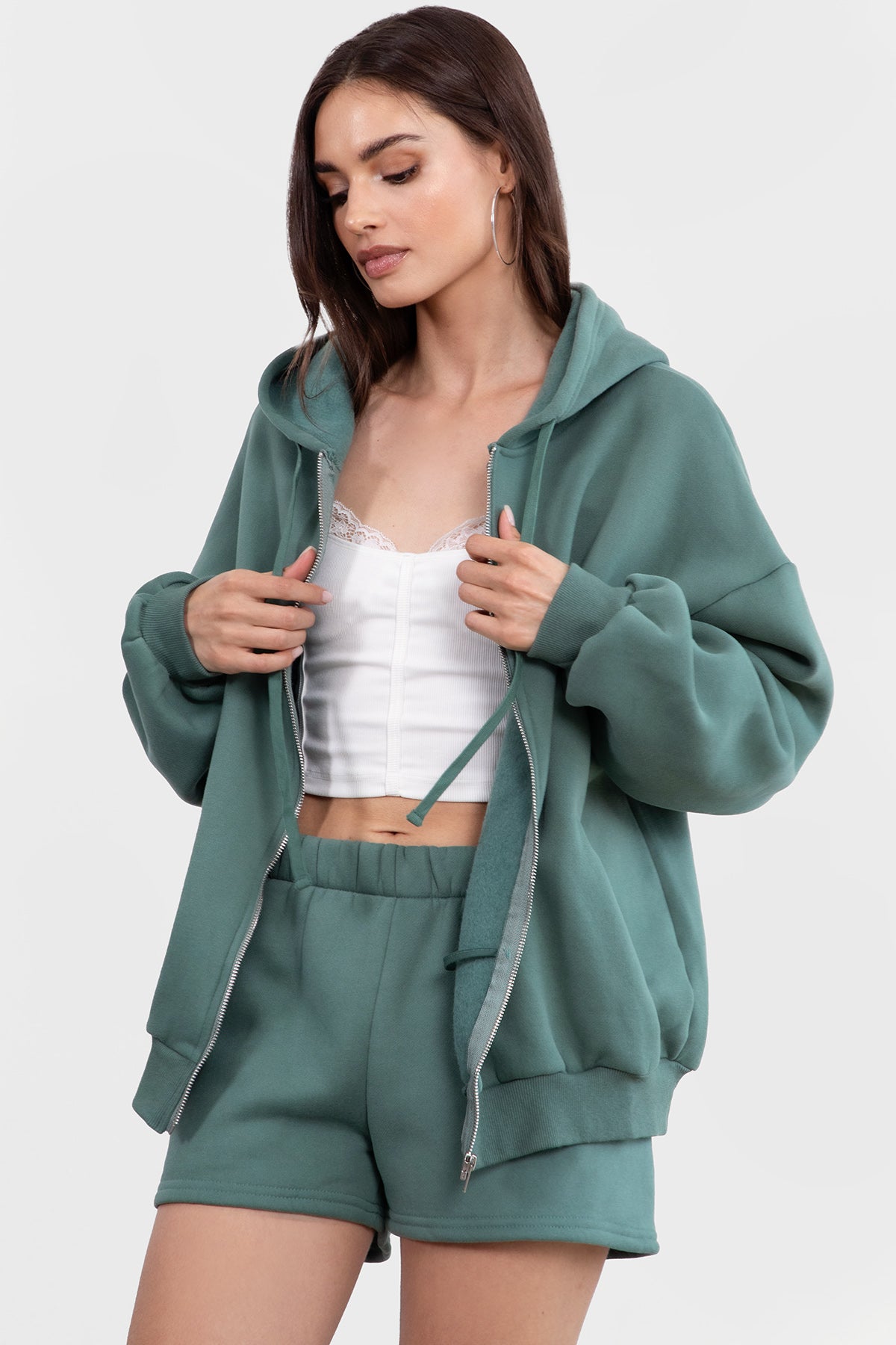 Pine green oversized hoodie with side welt pockets and an adjustable drawstring hood for a cozy feel by Tic Toc.