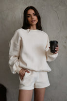 Relaxed fit fleece sweater for women with dropped shoulders and plush cozy fabric in ecru